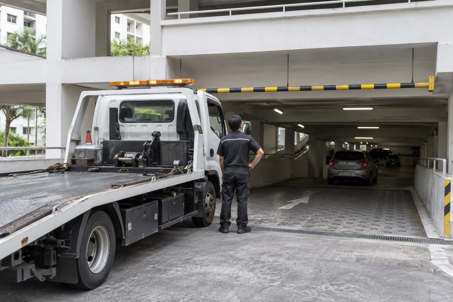 Tow operator checking a height-restricted carpark entrance